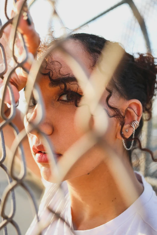 young woman with closed eyes leaning over fence