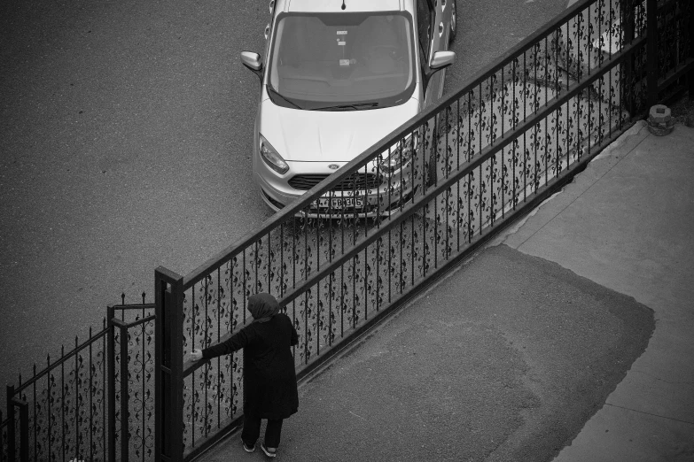 someone standing on a porch beside an automobile