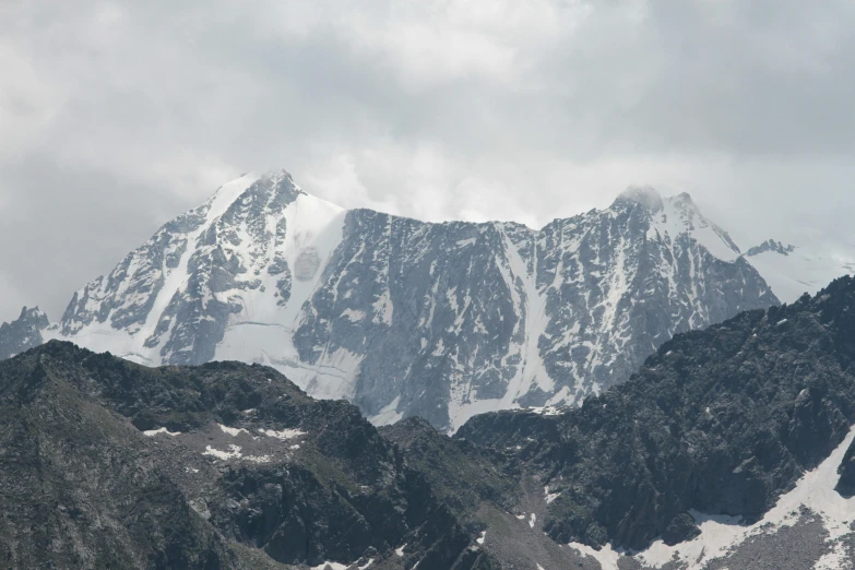 a tall mountain that has a very big snow covered hill in it