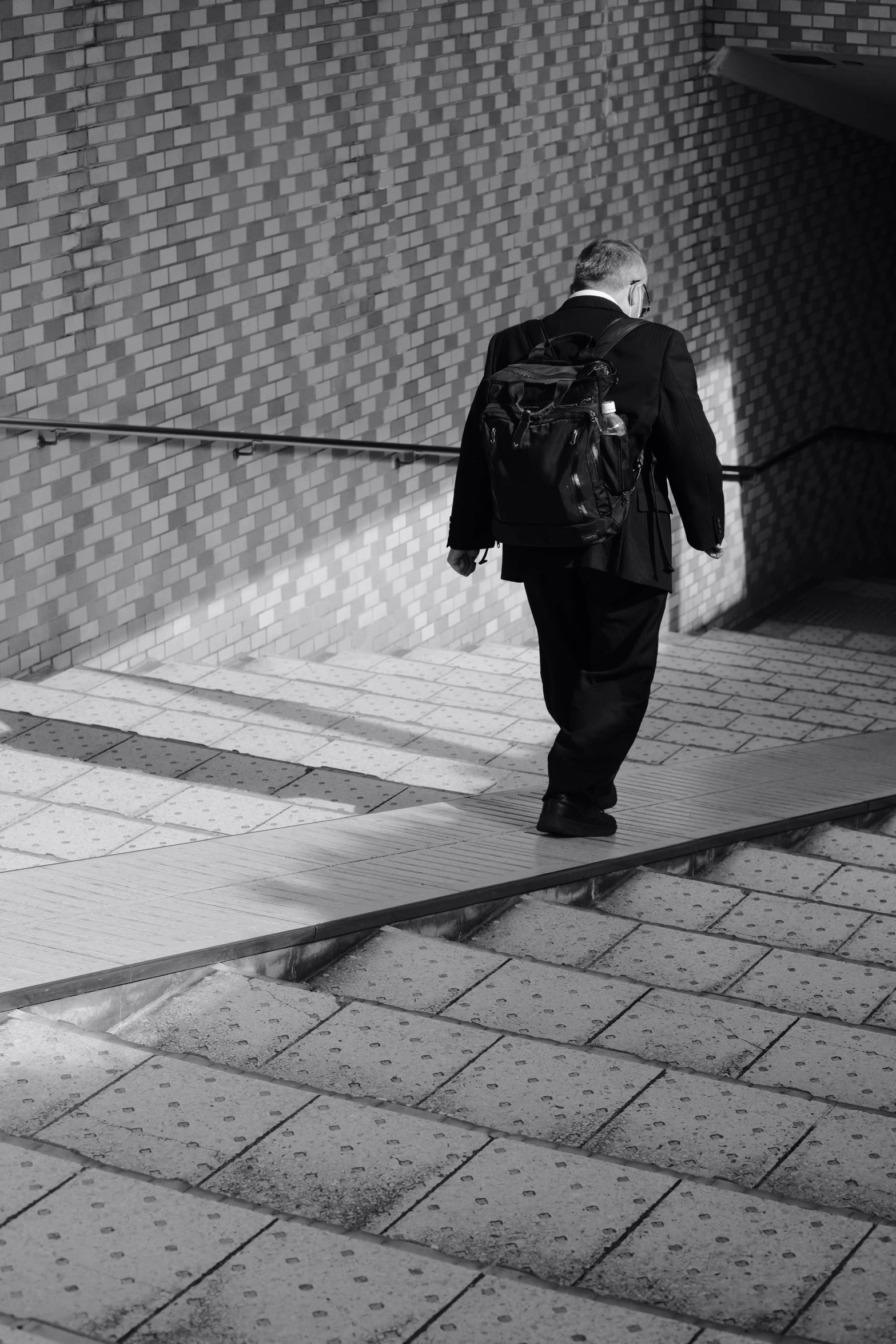 a black and white po of a man walking down a street