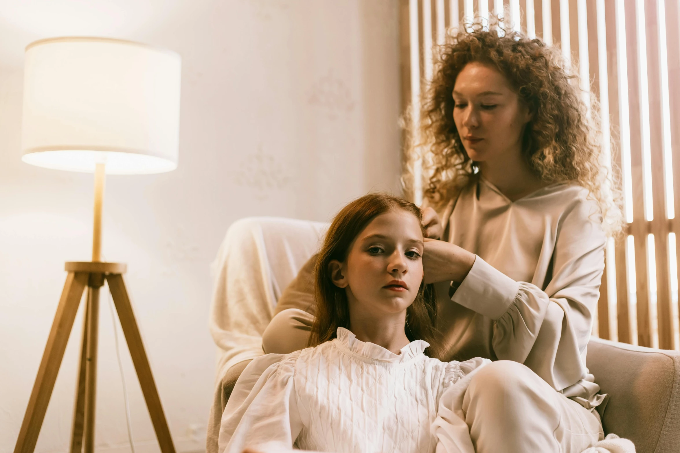 two women sitting down looking at soing