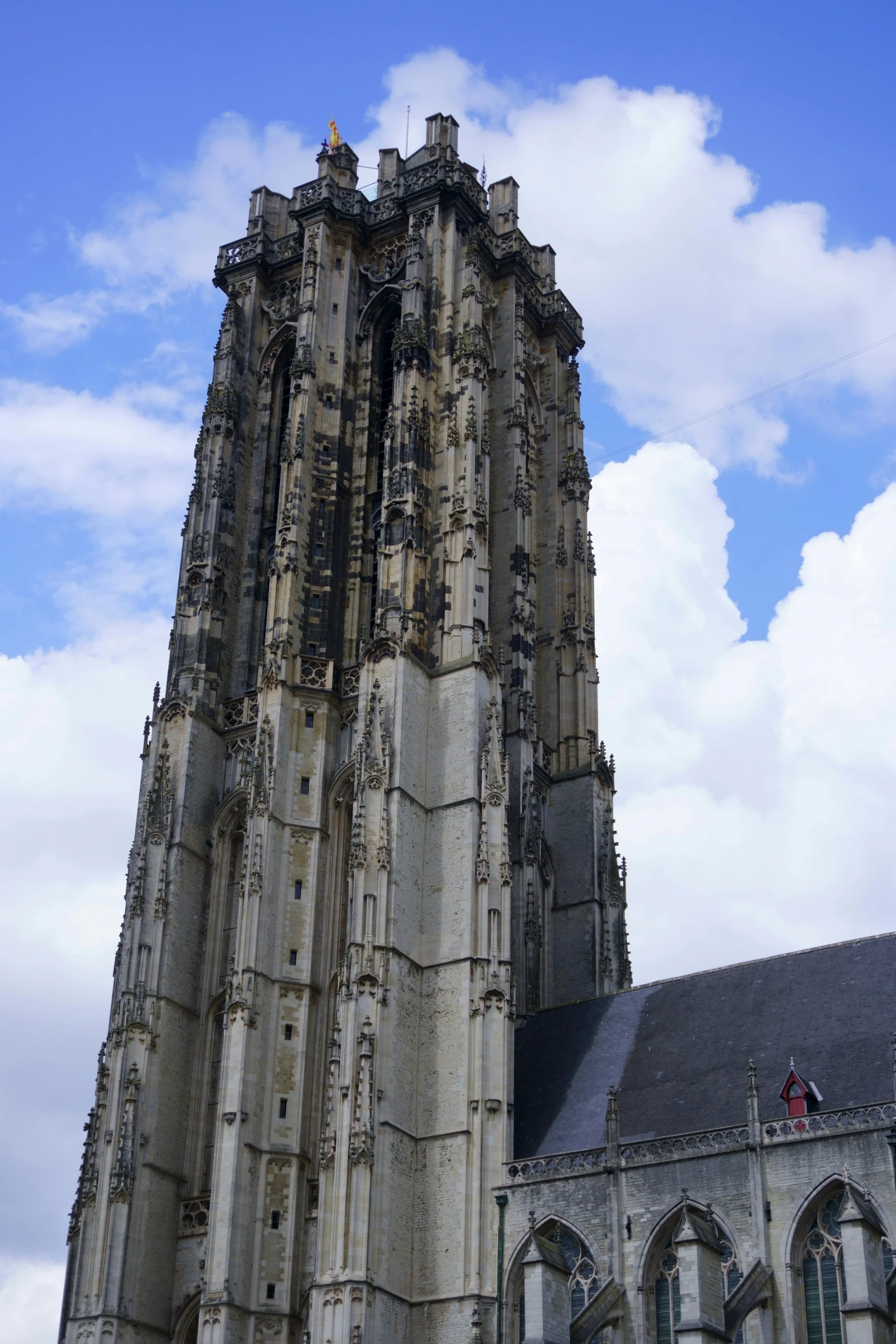 a stone tower with an ornate roof and windows