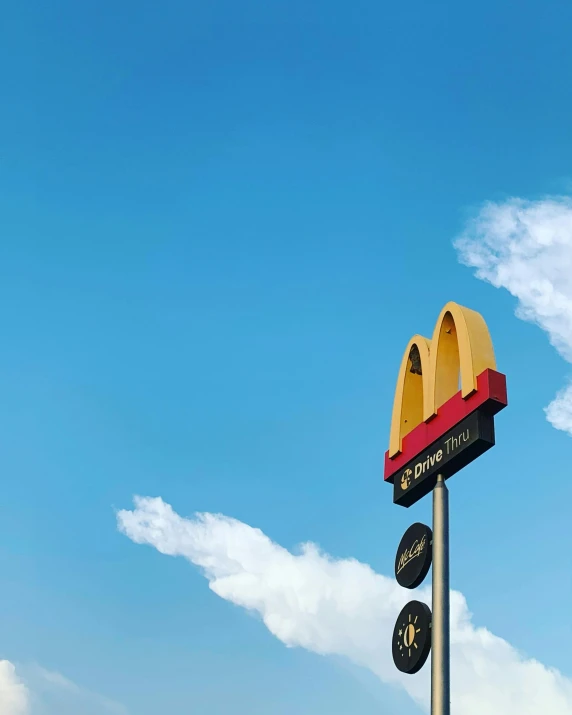 a large mcdonald's hamburger sign in the foreground