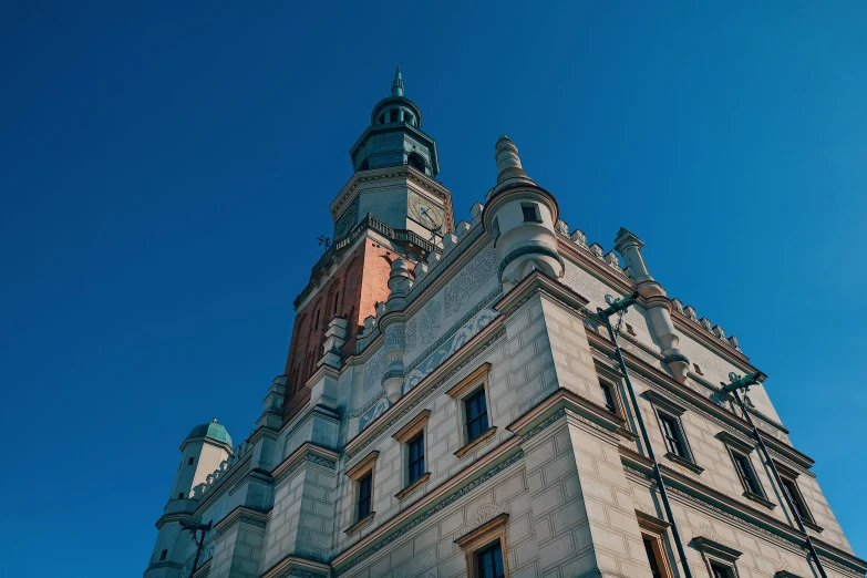 an old building with many steeple towers against a blue sky