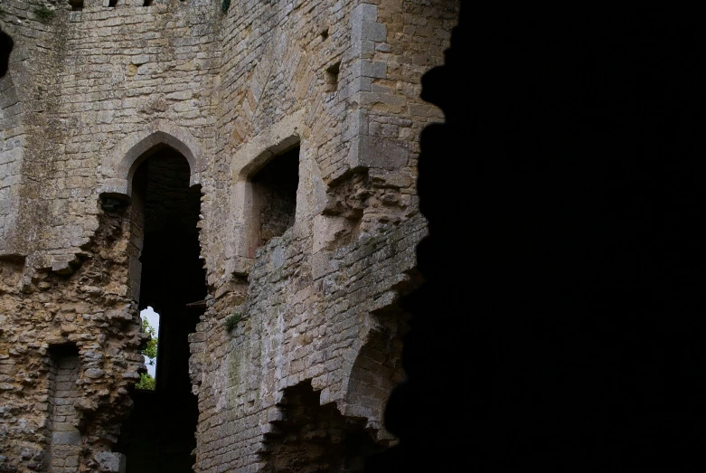 an old tower with a man climbing into the top