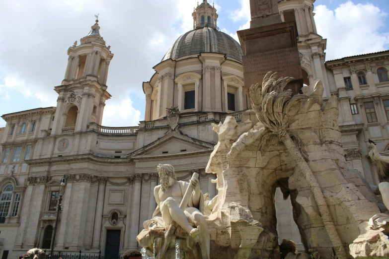 a close up of a fountain in front of a large building