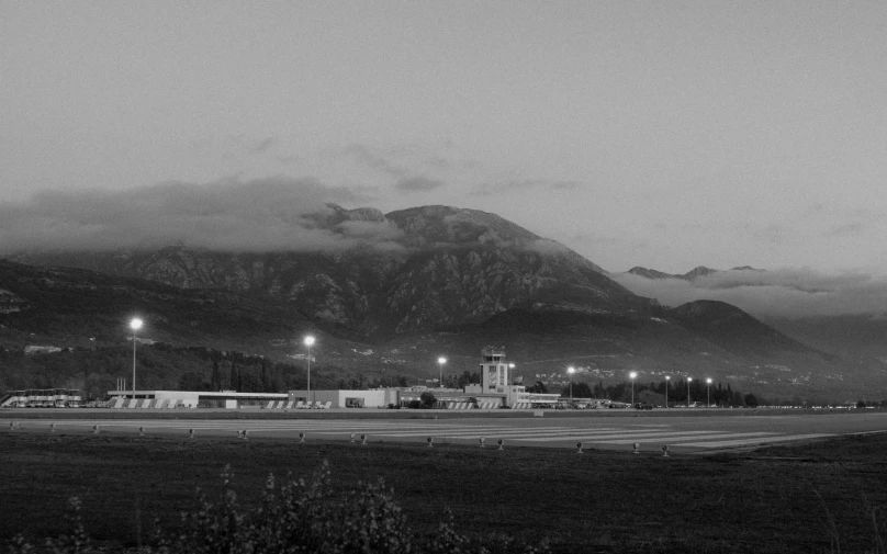 a picture of an airport with mountains in the background