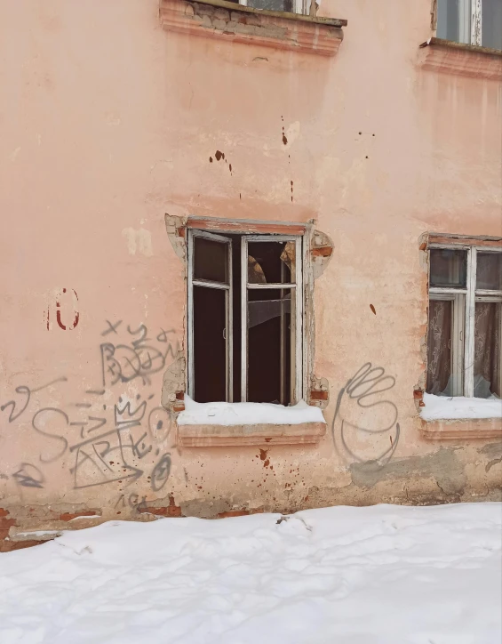 a large building has some windows and snow