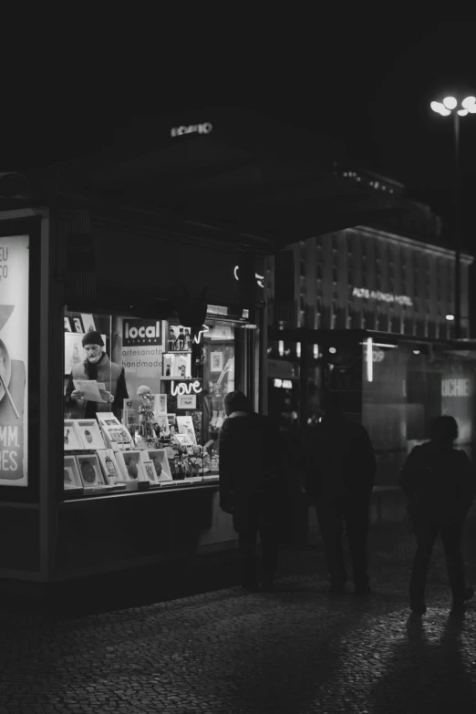 a couple of people that are standing outside of a store