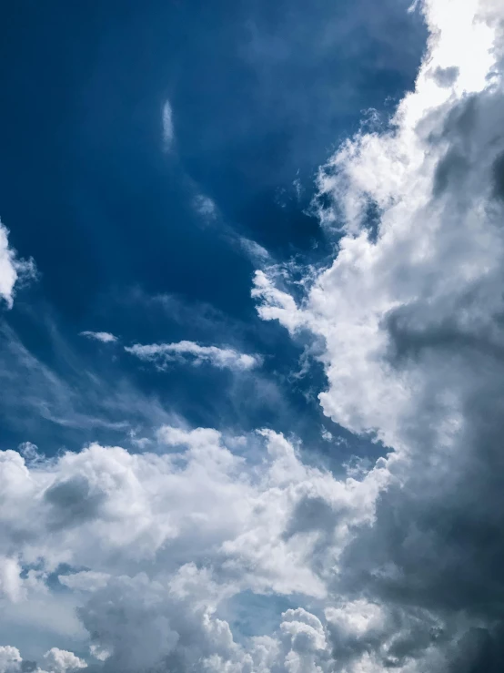 a large jetliner flying through a blue cloudy sky