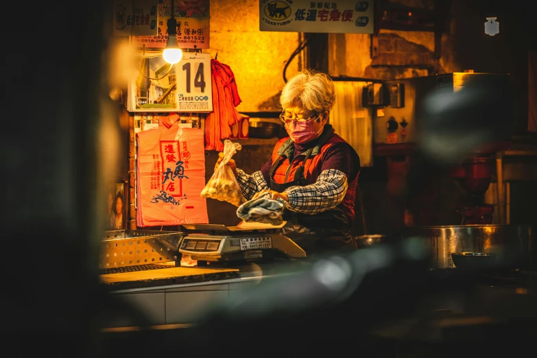 woman sitting in a kitchen cooking in a pot