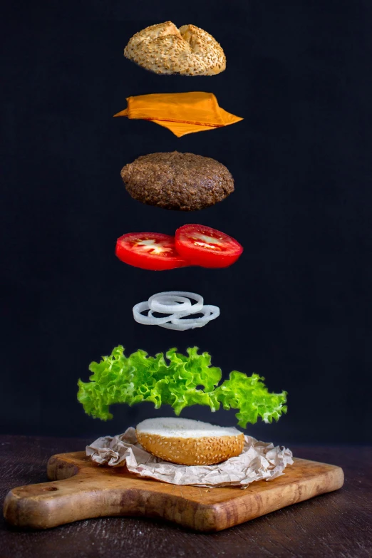 an image of hamburgers being tossed above it