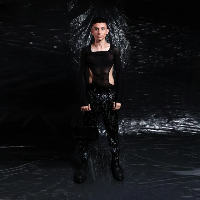 a female wearing black is standing next to water