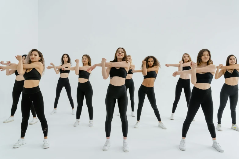 woman dancers with arms out standing in a sequence