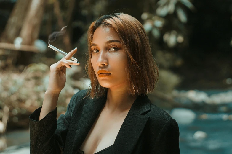 a woman is smoking and looking into the camera