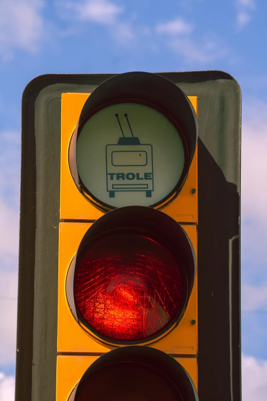 a yellow traffic light with red lights at the bottom