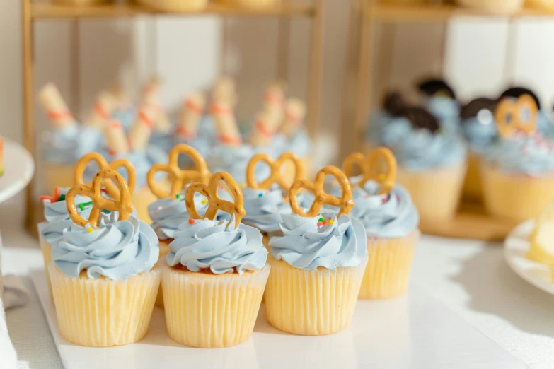 a row of cupcakes on a table at a birthday party