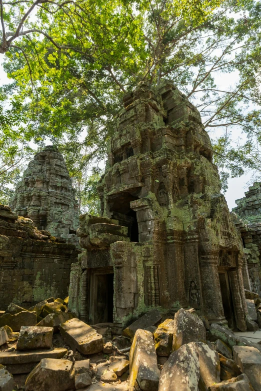 a very old, abandoned building with some trees in front