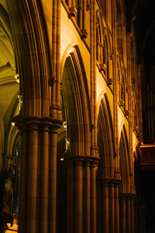 the inside of a cathedral with a clock and some pillars