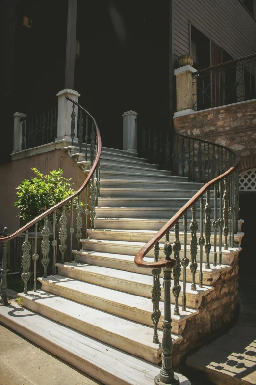 a stair case with metal handrails next to a brick house