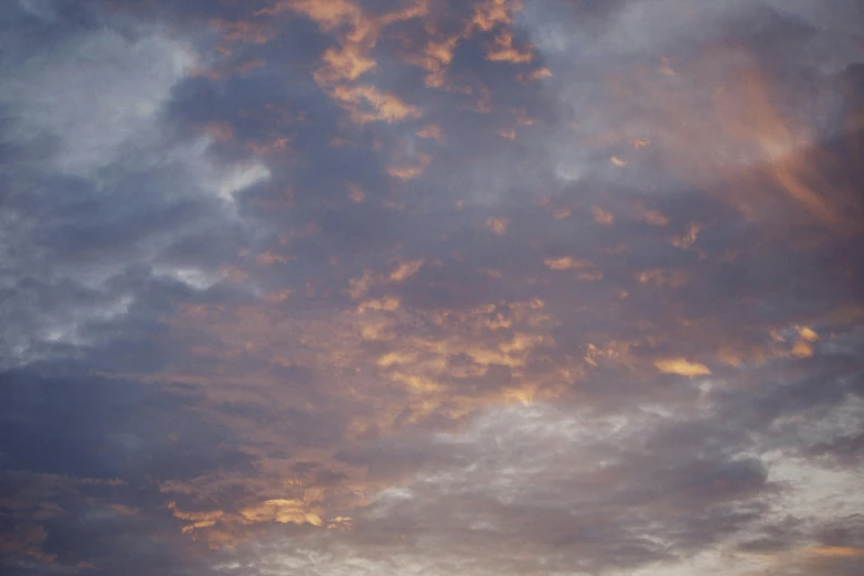 the clouds are covering a light blue sky