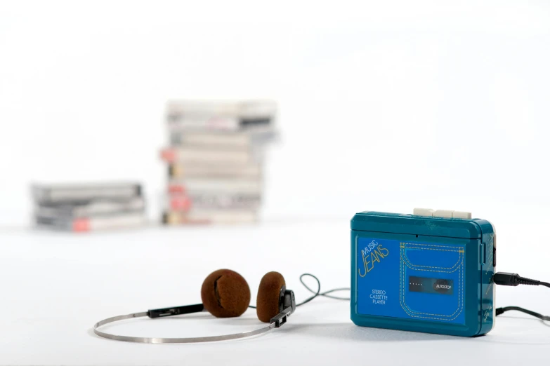 blue headphones next to blue and silver cassette recorder