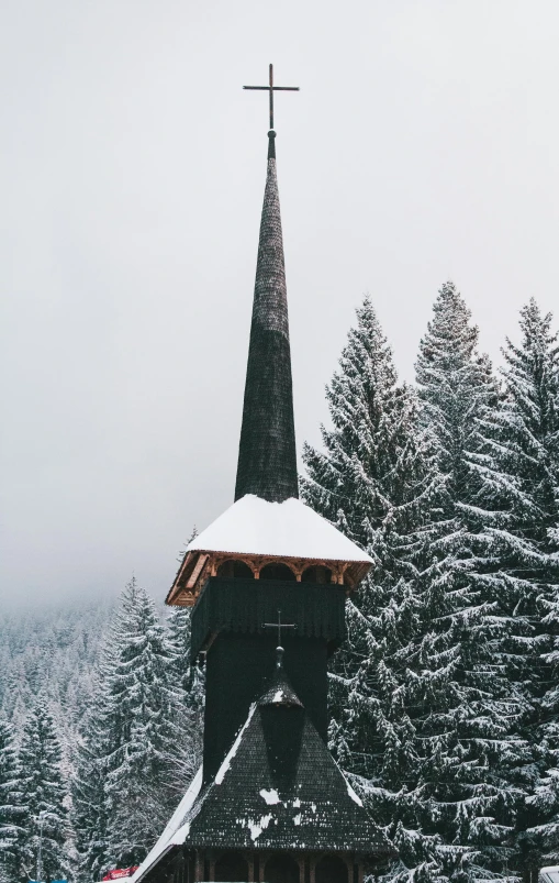 a church steeple with a large cross on top