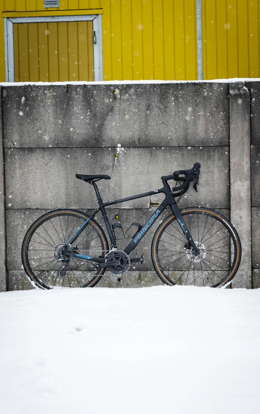 a bicycle that is parked near a wall