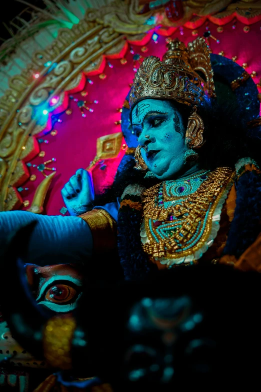 an idol is being painted and displayed in a dark room