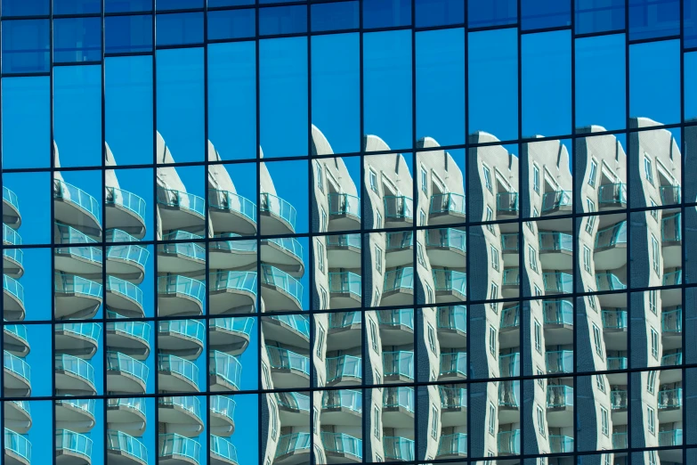 the building reflected in the glass windows shows the shape of the building