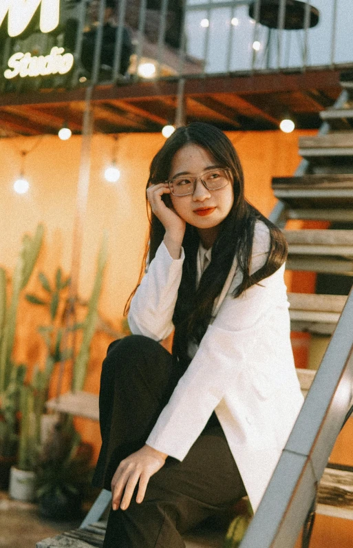 woman sitting on steps with a smile on her face