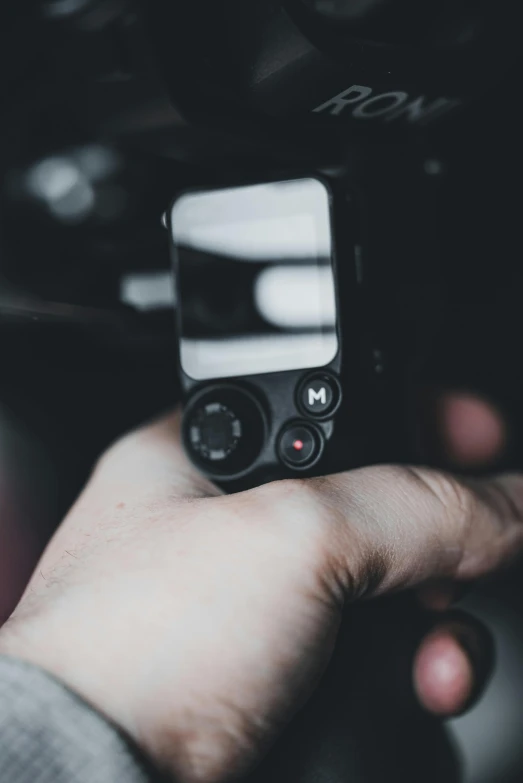 a close up of a person holding an electronic device