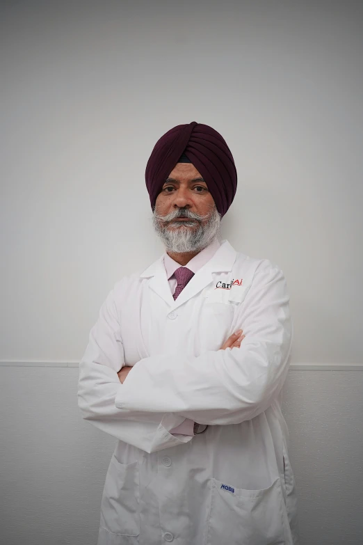 a man in lab coat standing with his arms crossed