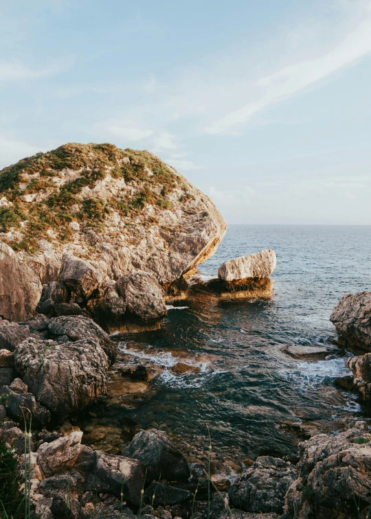 a rock sits in the middle of water