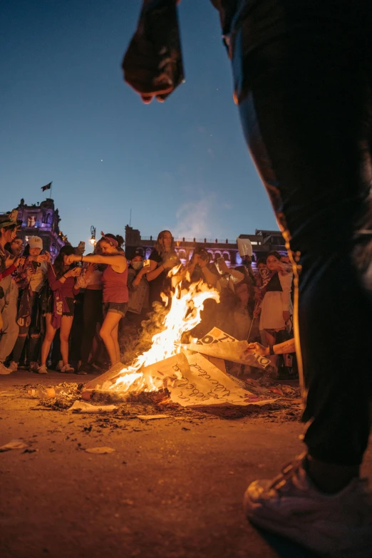 a bonfire is shown in the middle of a crowd