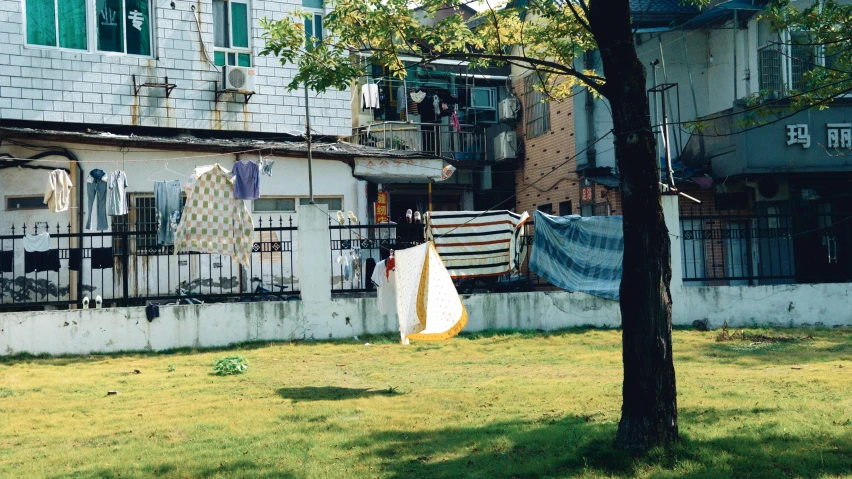 clothes are drying out on a washing line in front of an old building