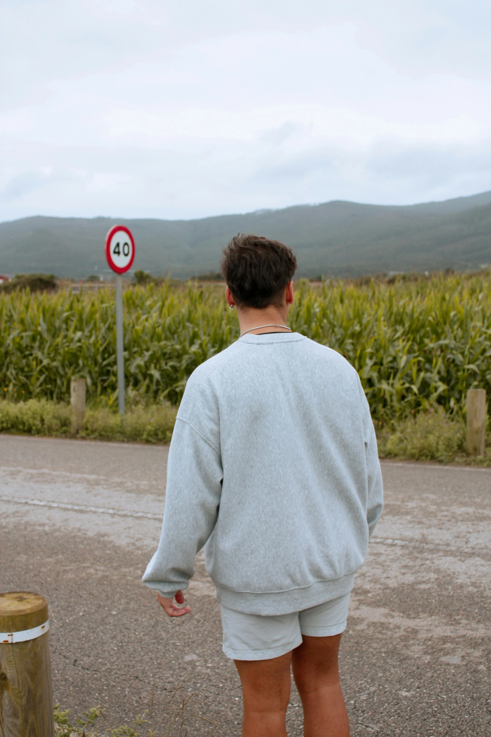 a person is walking down the road in shorts