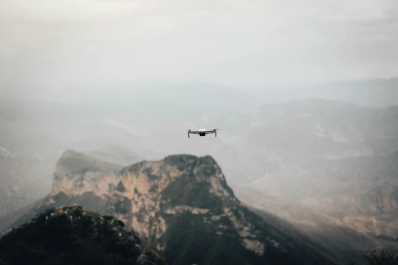 an airplane is flying over the top of a mountain