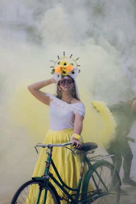 a woman in a costume and wig standing next to a bicycle