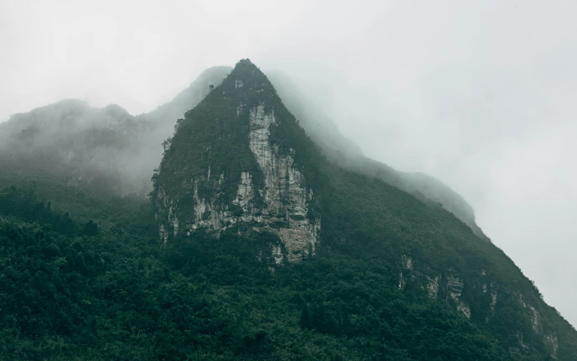 a mountain with a very tall cliff sticking out of it