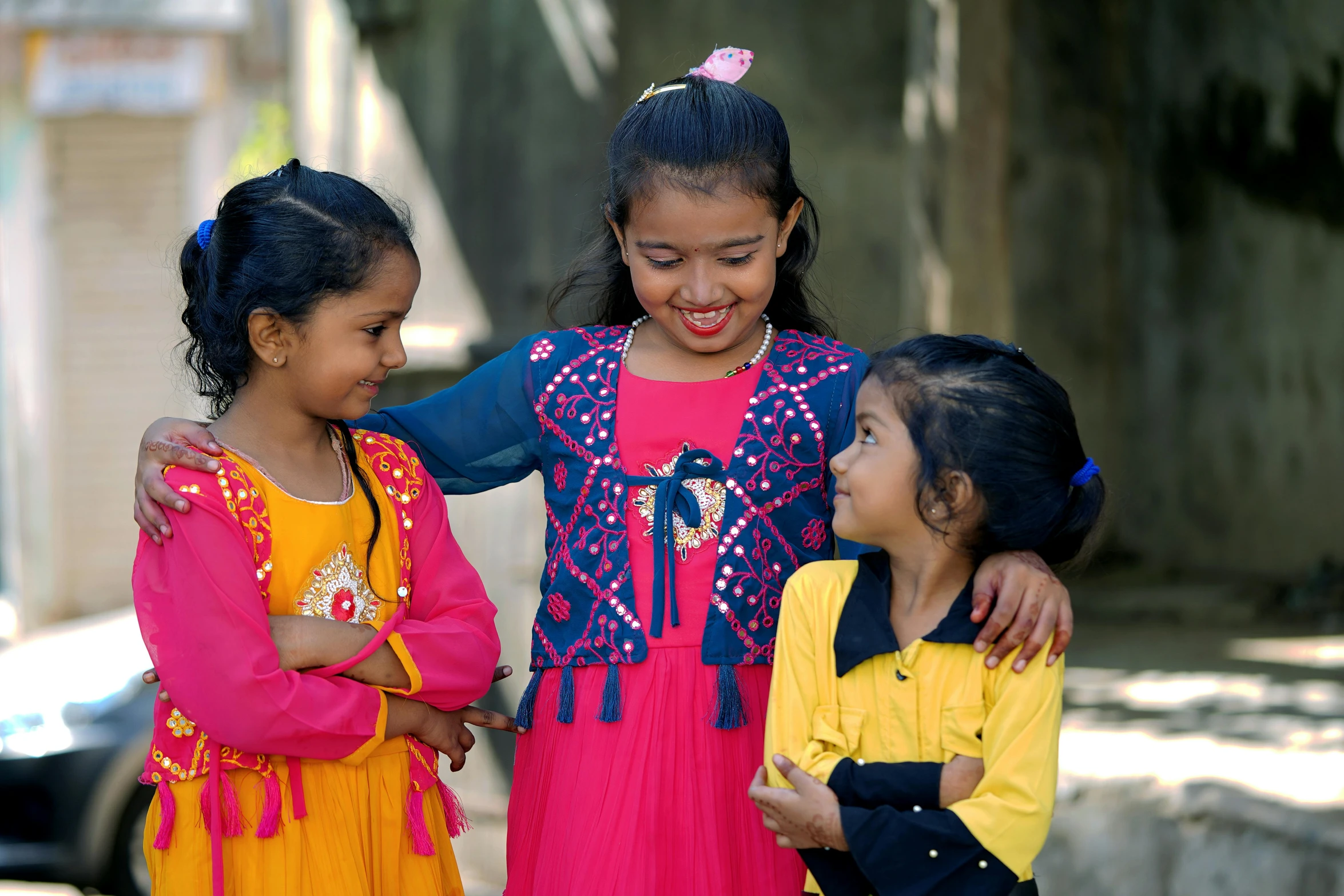 there are four children standing together in a group