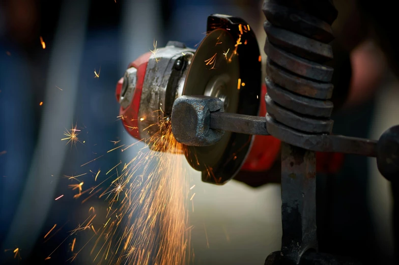 a person working with sparks in the background