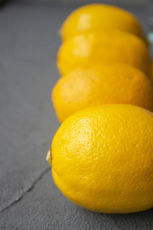 a row of lemons lined up on a table