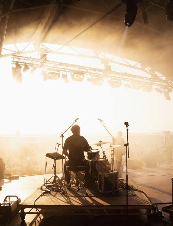 a band plays on stage under an umbrella