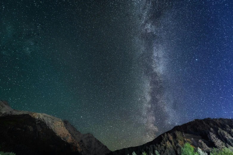 stars over the rocky mountains at night time