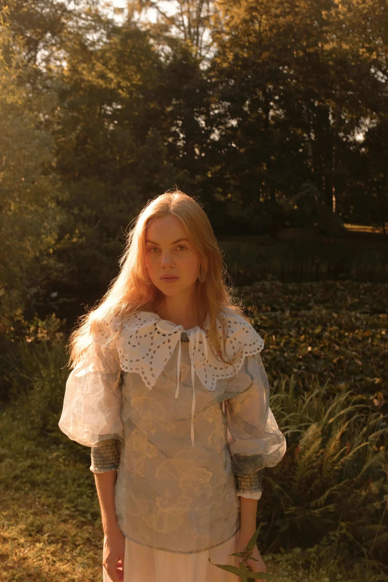 a woman is standing in the grass by herself