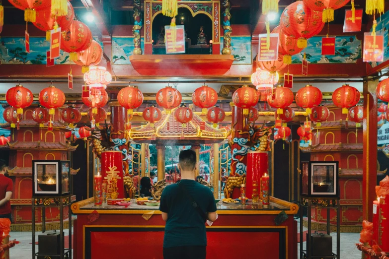 an asian shrine is adorned with lanterns and gold accents