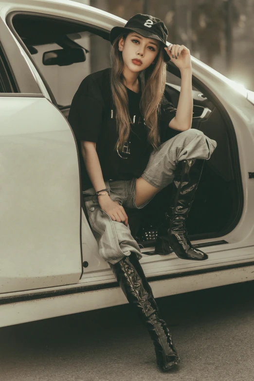 a young woman sits in the side door of a car