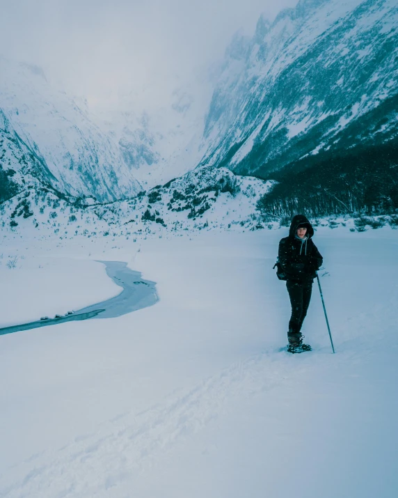 a person cross country skiing in a snowy mountain