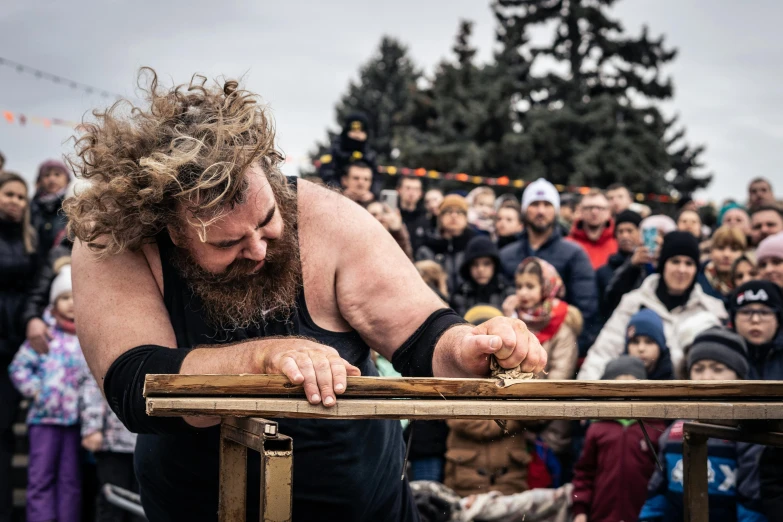 a guy in a wrestling ring holds his head above the ropes